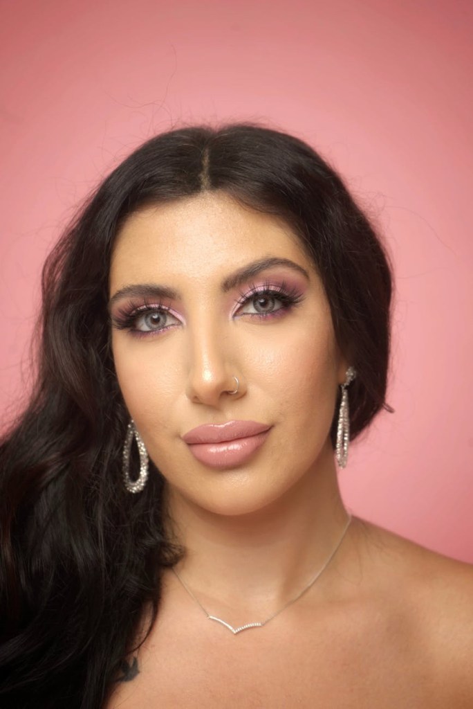 Woman with long, voluminous eyelashes, looking confident and radiant.